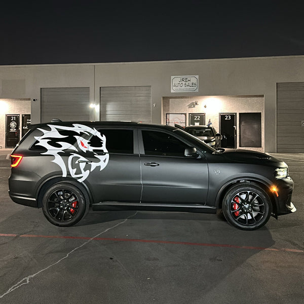 Dark-colored SUV with a white logo on a dark background