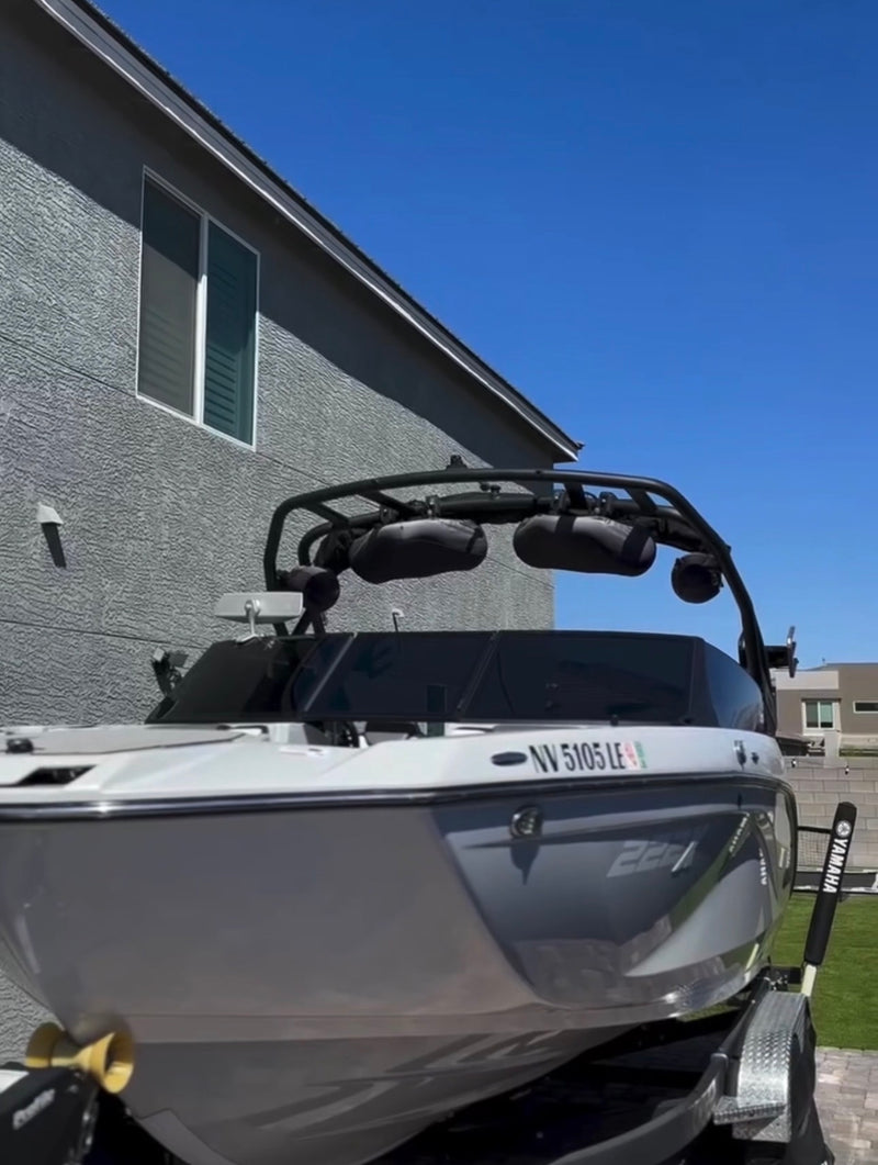 White Yamaha boat on a trailer with a clear blue sky and building in the background